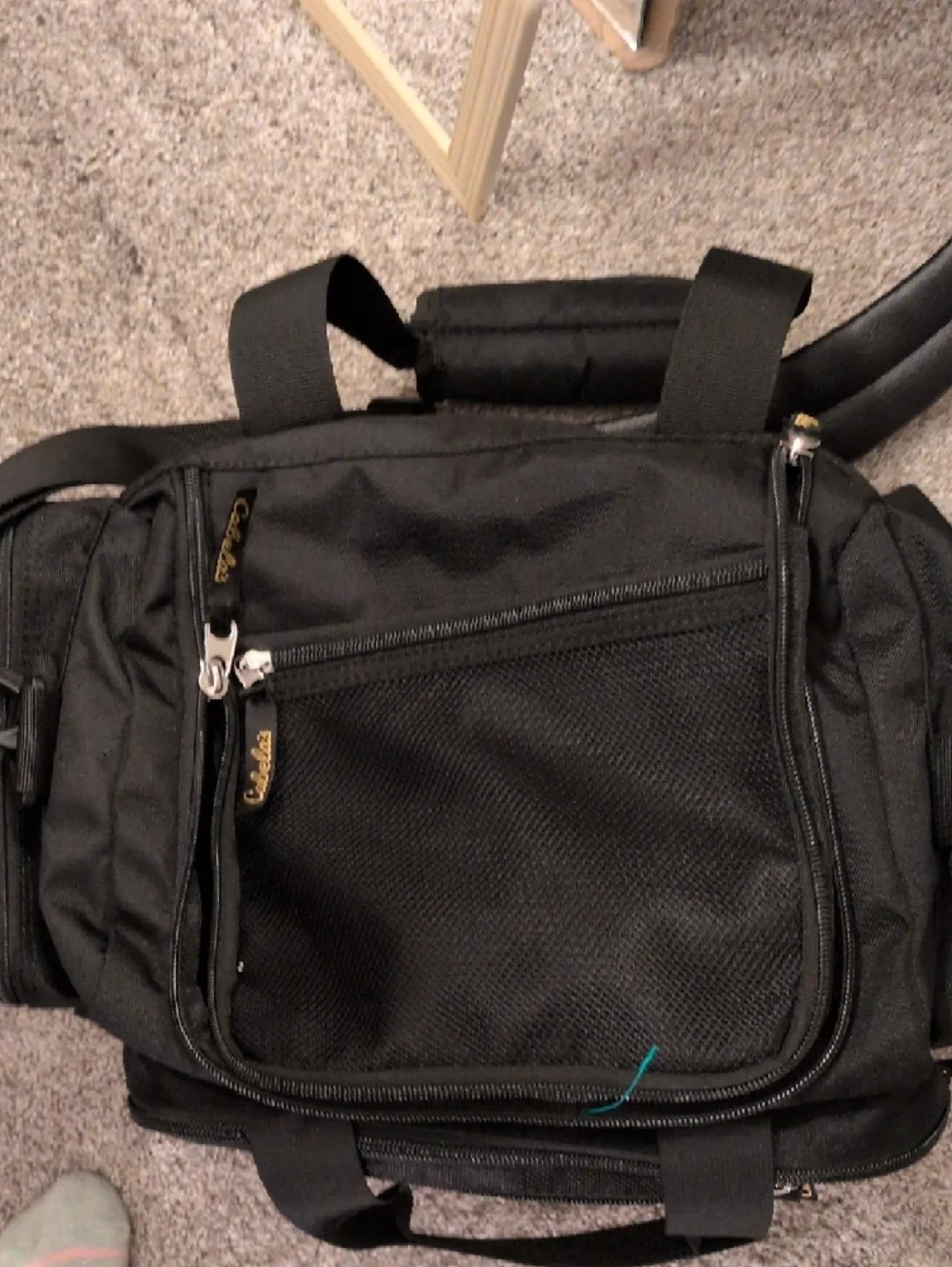 Cabela's Black Duffel Bag with Gold Logo and Adjustable Strap